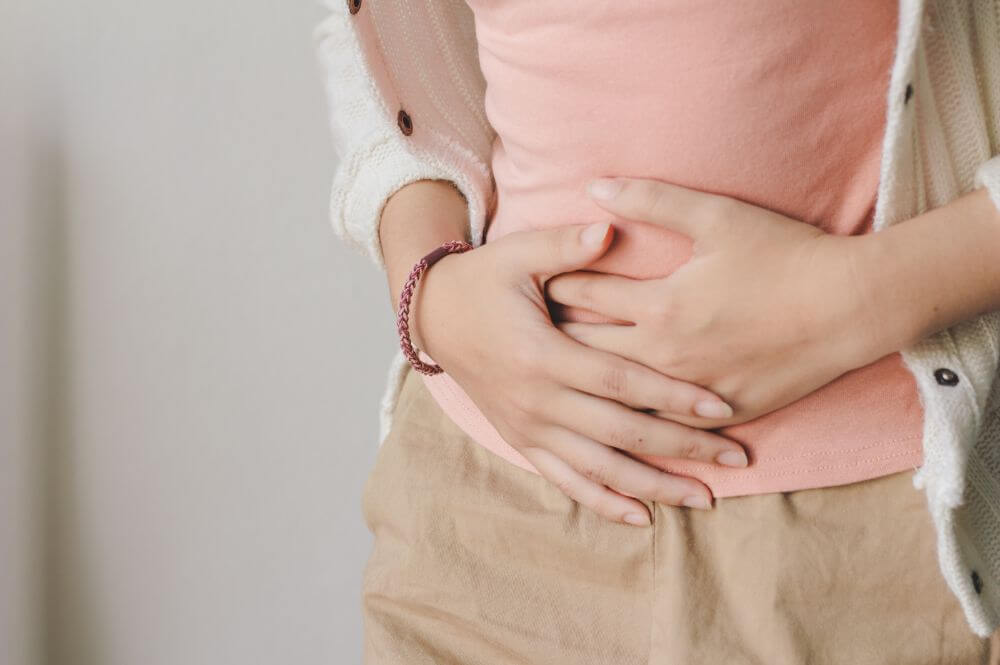 a woman experiencing stomach pain